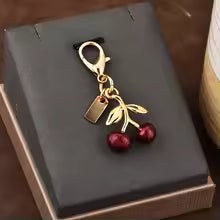 https://res.cloudinary.com/dyql5hig8/image/upload/v1743979221/config/images/cherry_bag_charm_mgwrpi.avif
